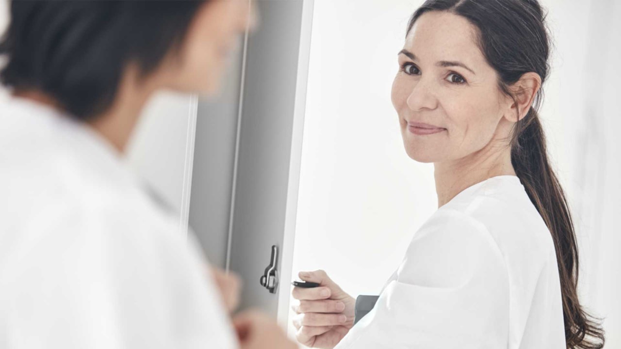 2 nurses and one is opening a door