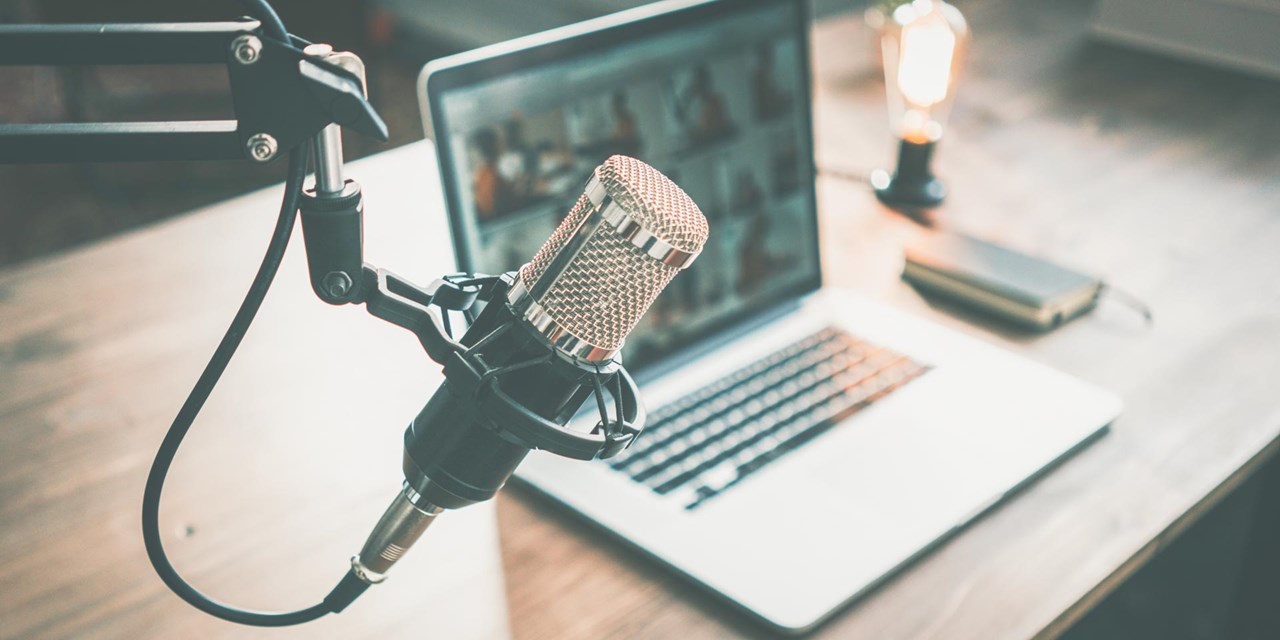 Podcast microphone on table with laptop