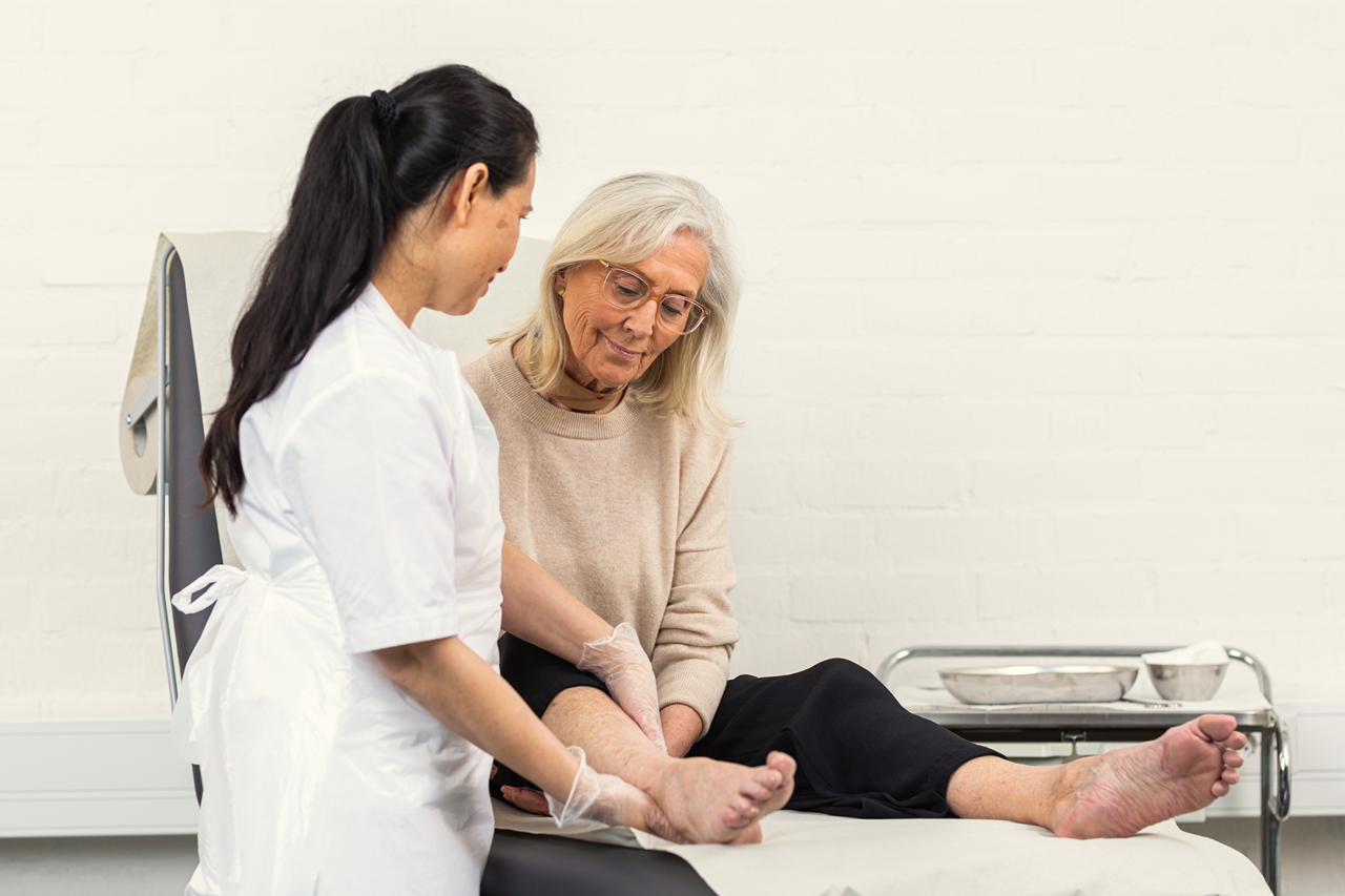 Patient in bed and nurse standing 