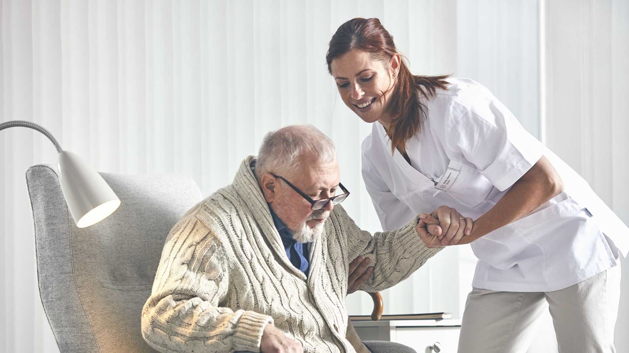 Home Care nurse tending to an elderly patient