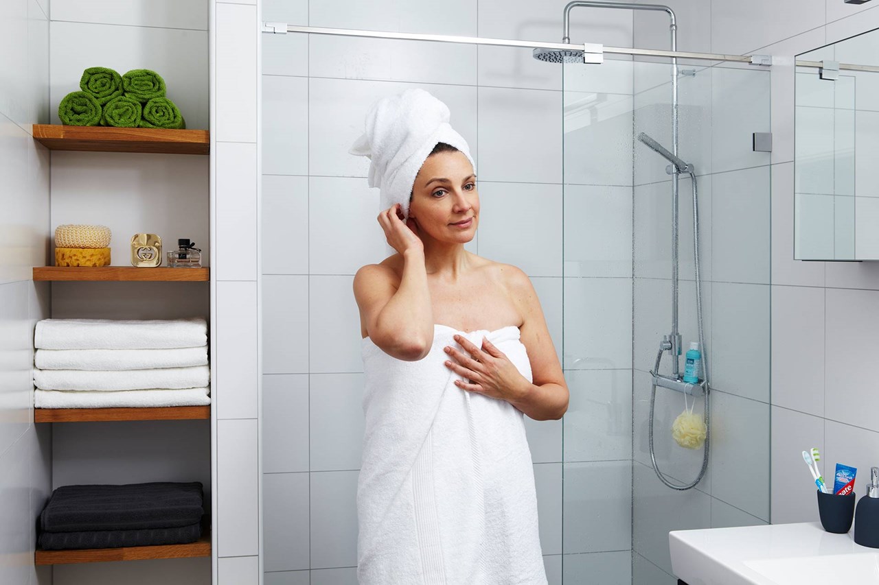 Woman in a bathroo after taking a shower